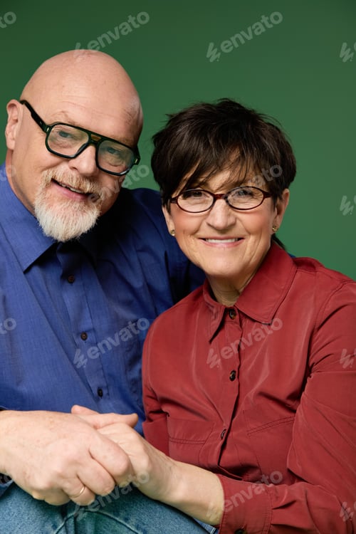 Preview: Loving senior couple shares a tender moment while holding hands and smiling warmly