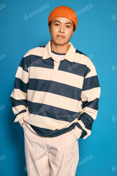 Preview: Stylish young man expressing modern fashion sense in a vibrant studio setting