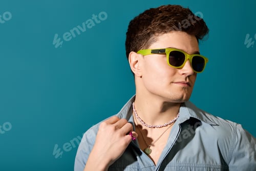 Preview: Stylish young man enjoying summer vibes with trendy accessories and vibrant colors