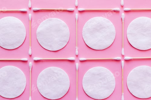Preview: Flat Lay of White Cotton Pads and Ear Sticks on Pink Background, Top View