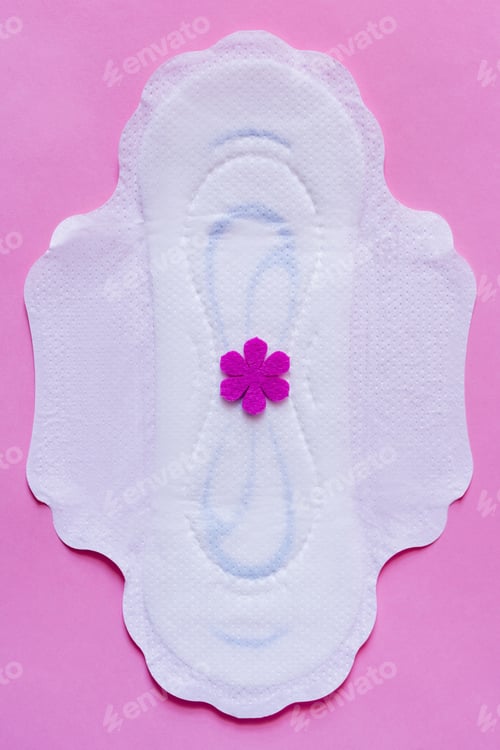 Preview: Top View of White Panty Liner With Purple Flower on Violet Background