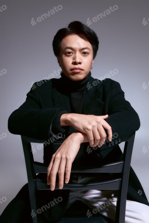 Preview: Stylish young man demonstrates modern fashion trends in a studio setting