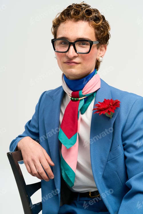 Preview: Stylish young man models trendy outfit with vibrant colors in a studio setting