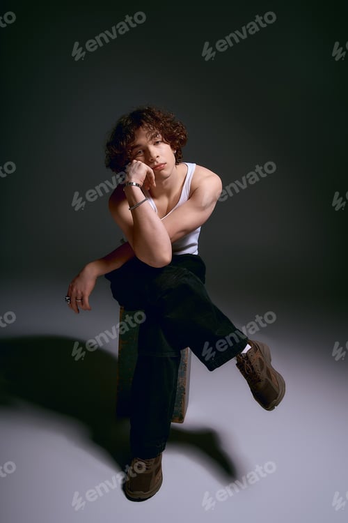 Preview: Emotional young man in stylish attire captures attention with captivating expression