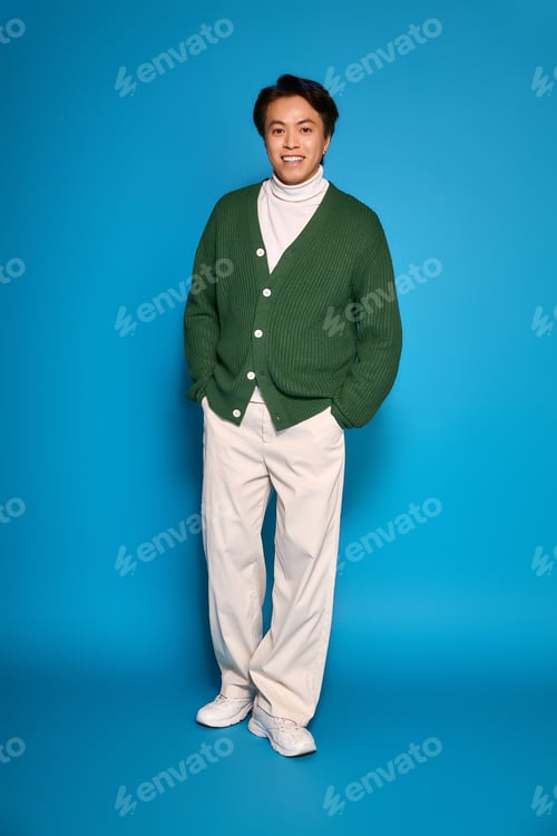 Preview: Stylish young man exhibits modern fashion trends in vibrant studio setting
