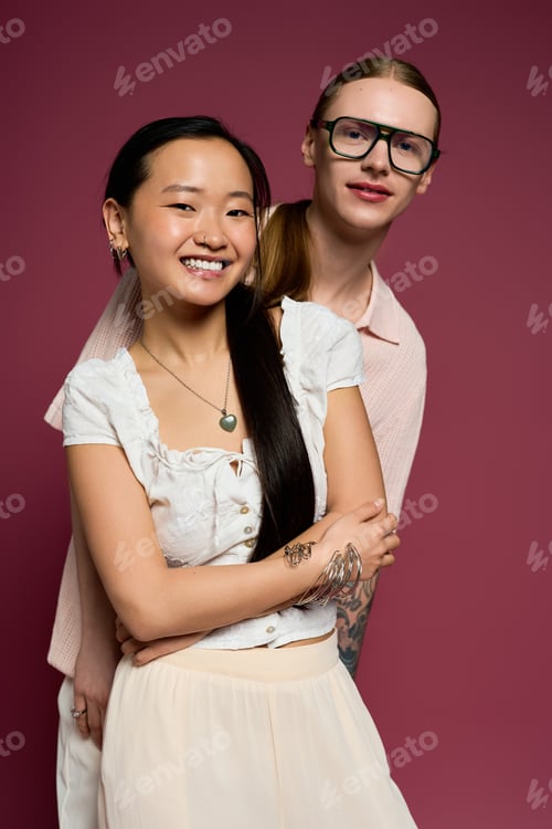 Preview: Young couple sharing a joyful moment against a vibrant background in a creative studio setting