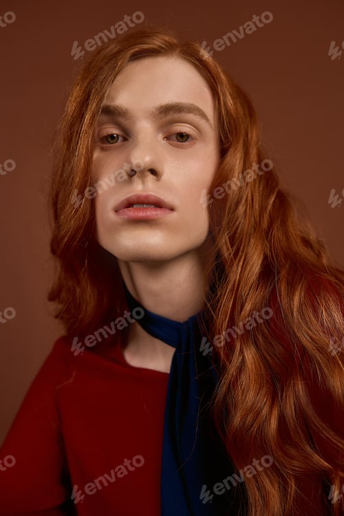 Preview: Handsome young man with long red hair showcases elegant fashion style and charm in portrait