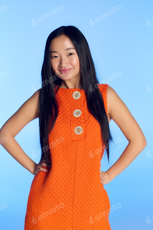 Preview: Elegant young woman embodies summer fashion in a vibrant studio setting