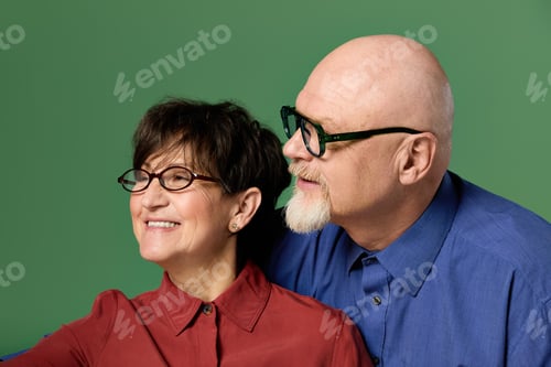 Preview: Joyful moments shared by a loving senior couple against a vibrant green backdrop