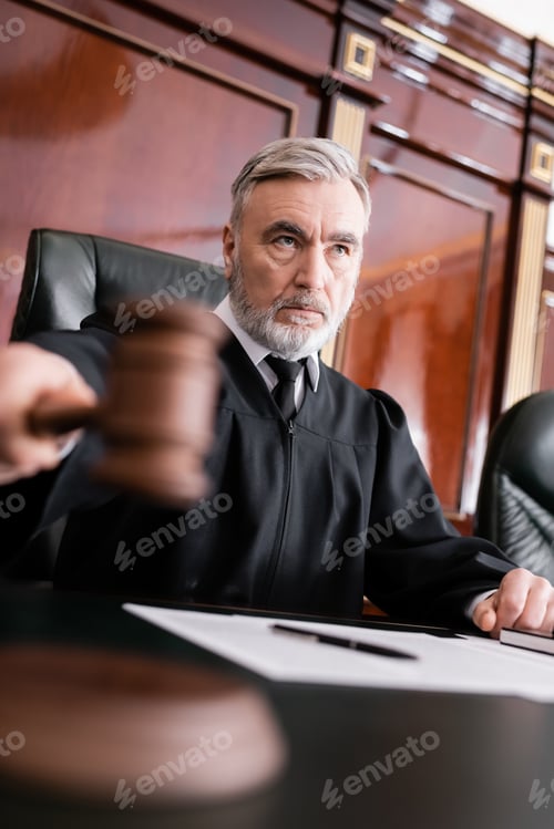 Preview: Grey-haired Judge With Blurred Gavel Sentencing in Courthouse