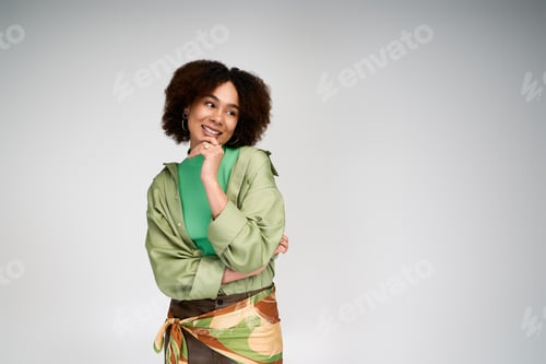 Preview: Charming woman in stylish attire exudes confidence and grace in a modern setting