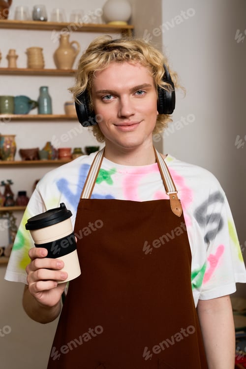 Preview: Crafting clay creations in a pottery workshop by a young artisan with curly blonde hair
