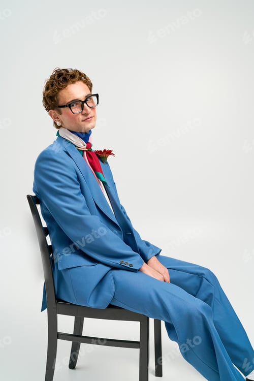 Preview: Stylish young man showcases modern fashion in vibrant outfit during studio session