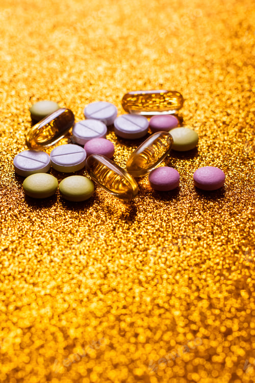 Preview: Different Colorful Pills and Capsules on Shiny Golden Background