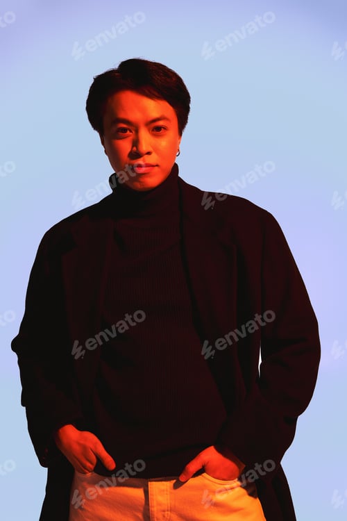 Preview: Stylish young man showcases trendy outfit in a modern studio setting