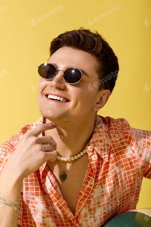 Preview: Stylish young man enjoying the summer vibes with a bright smile and chic fashion