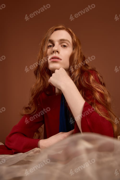 Preview: Handsome young man with long red hair showcasing elegance in stylish attire