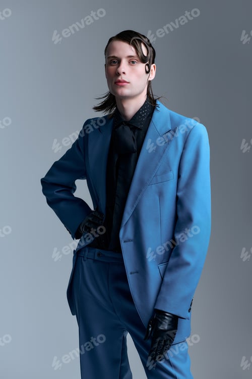 Preview: Stylish young man showcases modern fashion in a contemporary studio setting