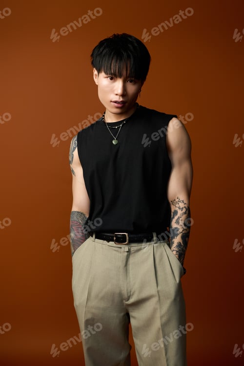 Preview: Young handsome man in stylish attire poses confidently against a rich brown background