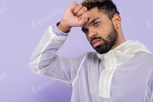 Preview: Portrait of Tired and Young African American Man With Blue Eyes Isolated on Purple