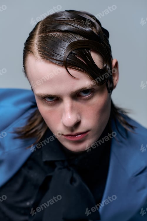 Preview: Stylish young man showcases modern fashion in a creative studio portrait session