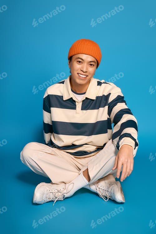 Preview: Stylish young man in vibrant studio setting showcasing modern fashion trends