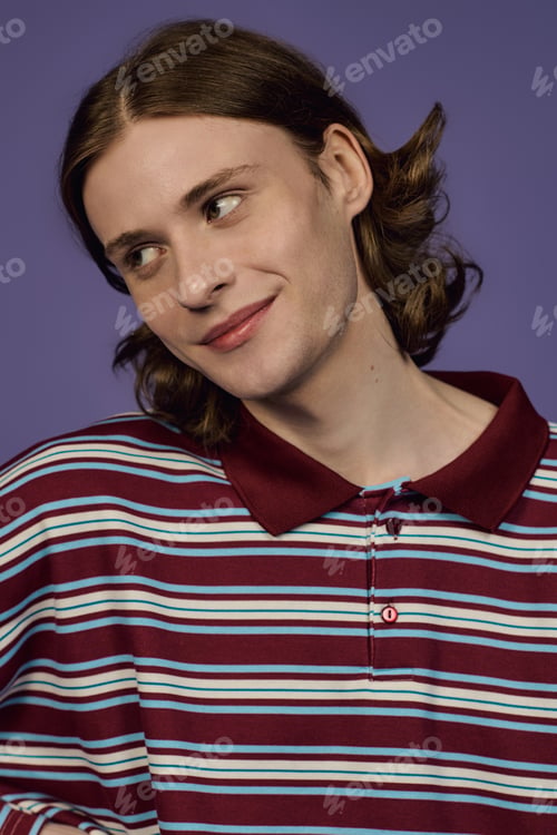 Preview: Young man showcases trendy style in a studio portrait full of personality and flair