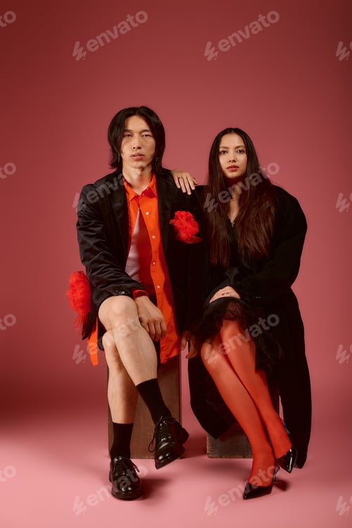 Preview: Stylish couple showcases modern romance against a vibrant pink backdrop in a creative setting