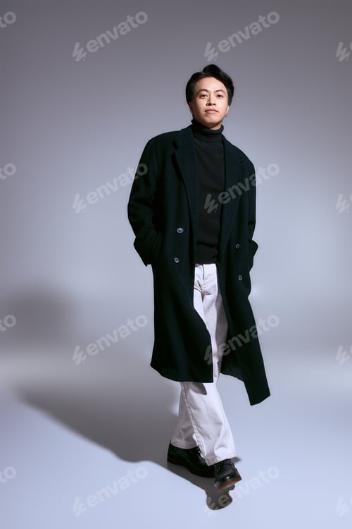 Preview: Stylish young asian man presents a modern fashion statement in a chic studio setting