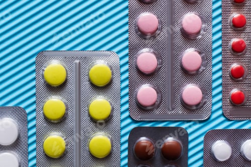 Preview: Close up View of Blister Packs With Different Pills on Blue Textured Background