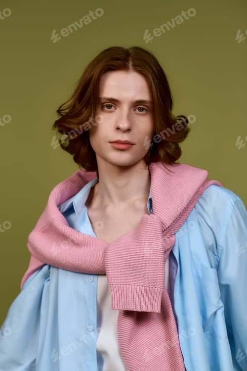 Preview: Stylish young man showcasing modern fashion trends in a vibrant studio setting
