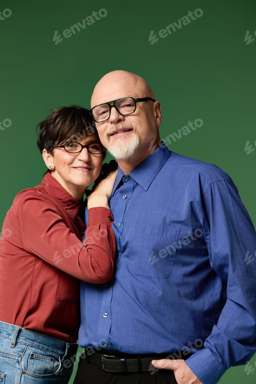 Preview: Senior couple embracing in a warm moment of love and connection against a vibrant green backdrop