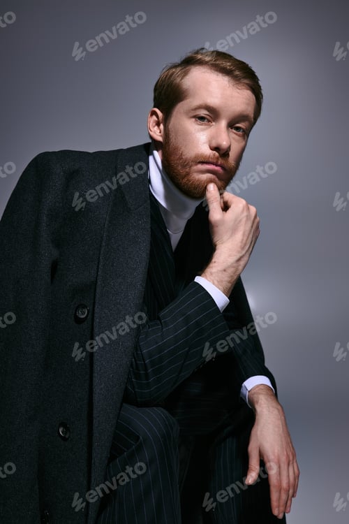 Preview: Handsome red haired man showcasing modern fashion in sophisticated studio lighting