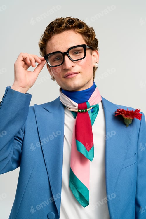 Preview: Stylish young man displays his unique fashion flair in a vibrant studio setting