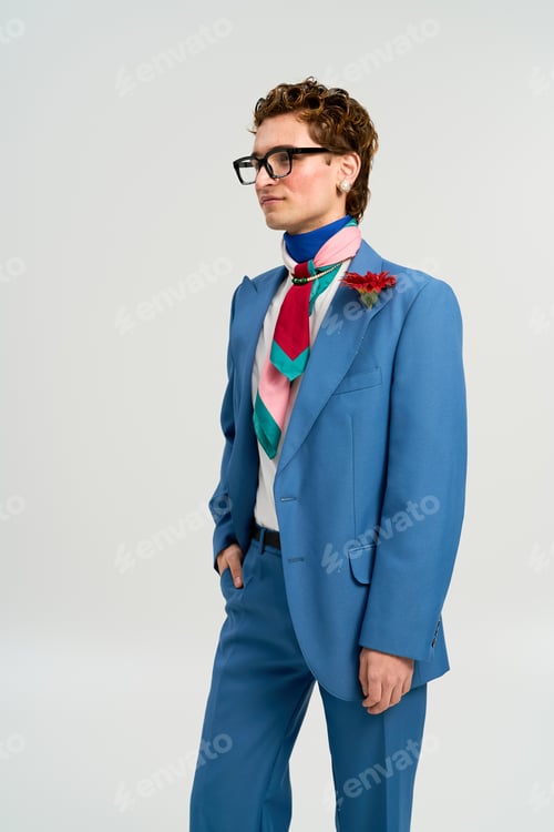 Preview: Stylish young man showcases vibrant fashion sense in modern studio setting