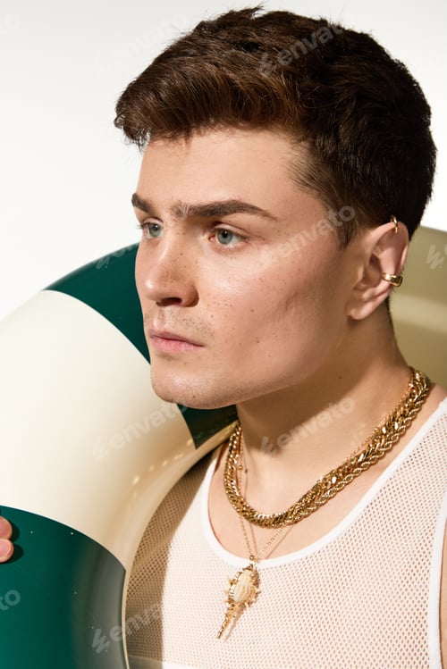 Preview: Stylish young man showcases summer fashion with a vibrant float in a lively setting