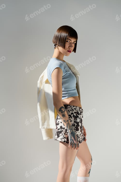 Preview: Fashion forward young woman showcases bold style with confidence and flair in a modern setting
