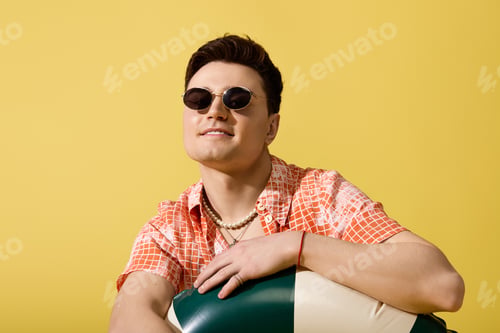 Preview: Stylish young man enjoys the summer vibes with a bold fashion statement and relaxed attitude