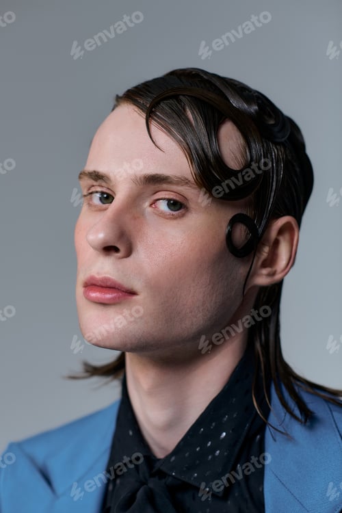 Preview: Stylish young man poses confidently in a modern studio setting showcasing fashion trends