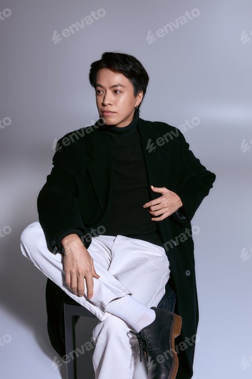 Preview: Stylish young man presents contemporary fashion in a modern studio setting