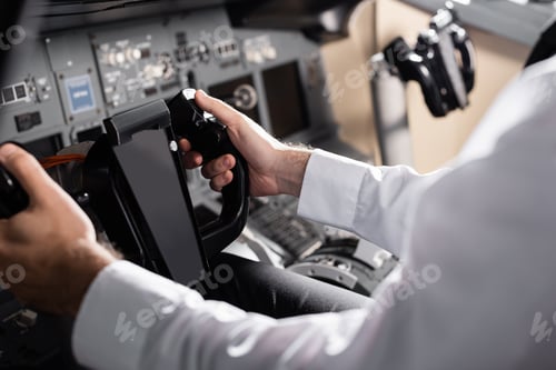Preview: Partial View of Pilot Using Yoke in Airplane Simulator