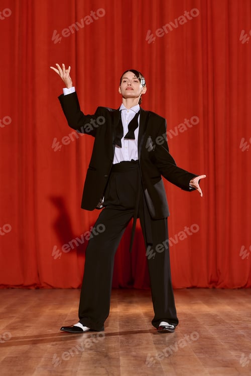 Preview: Vibrant performance by an artistic woman on stage with striking red backdrop during an evening show