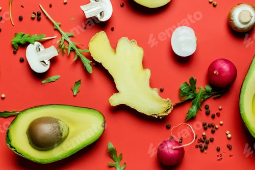 Preview: Top view of fresh food, greens and peppercorns on red background