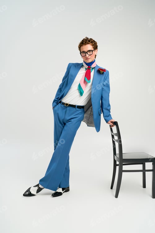 Preview: Stylish young man displays his unique fashion sense in a modern studio setting