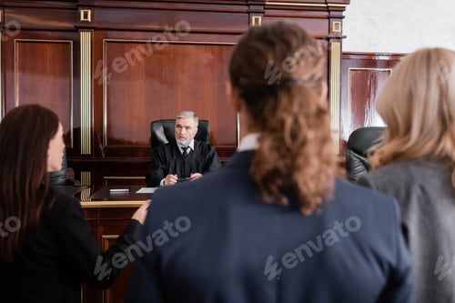 Preview: Prosecutor Talking to Senior Judge Near Accused Man and Advocate in Court