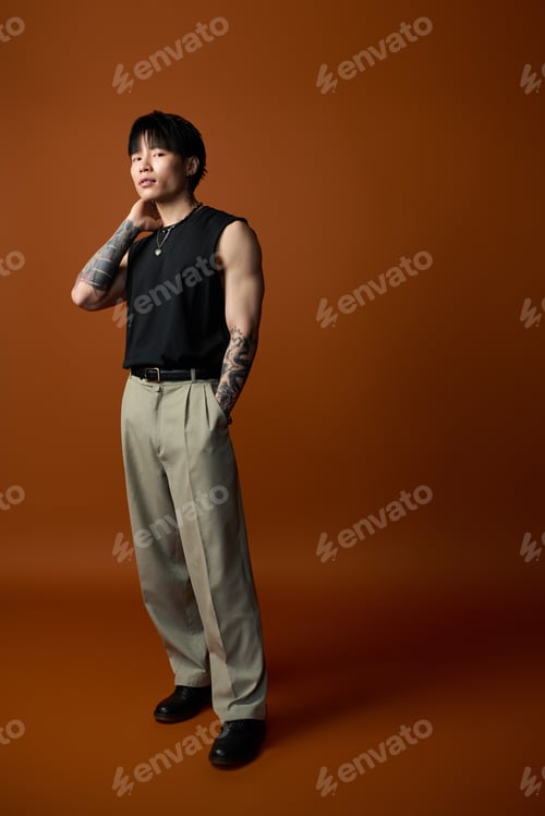 Preview: Young handsome man showcases style against a warm brown backdrop with confidence and flair