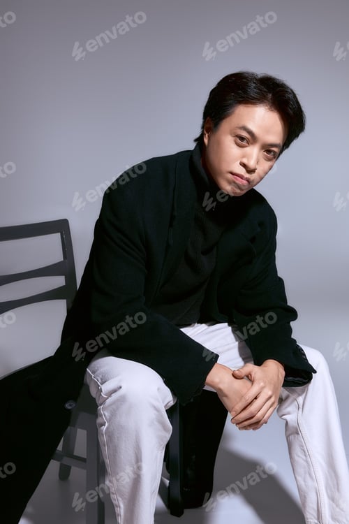 Preview: Stylish young man in a modern studio setting showcasing unique fashion choices