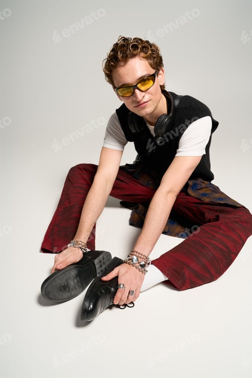 Preview: Fashion forward young man expresses creativity in trendy studio outfit
