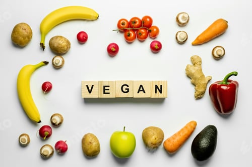 Preview: Top view of cubes with vegan lettering and fresh food on white background