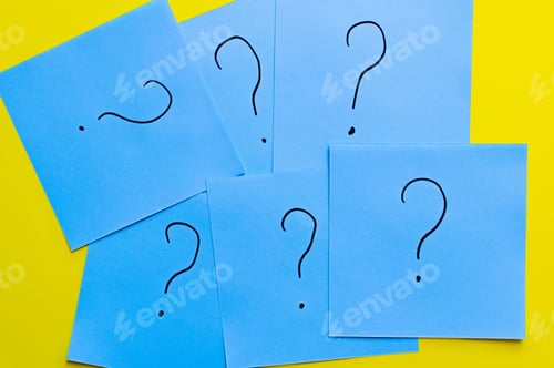 Preview: Top View of Question Marks Written on Blue Cards on Yellow Background